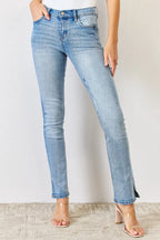 Light blue jeans worn by a person on a plain background