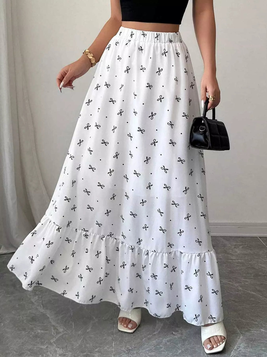 Person wearing a white floral skirt with a plain background