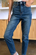 Person wearing blue jeans with a blurred background