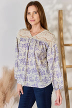 Woman wearing a floral blouse with a neutral background