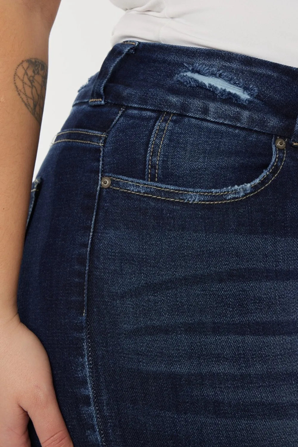 Close-up of blue jeans with a visible pocket and stitching detail.