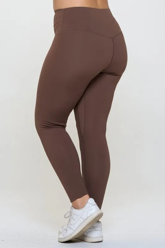 Brown leggings worn by a person on a white background