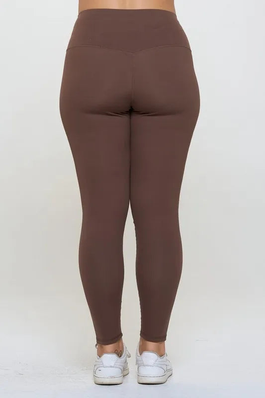 Brown leggings worn by a person on a white background