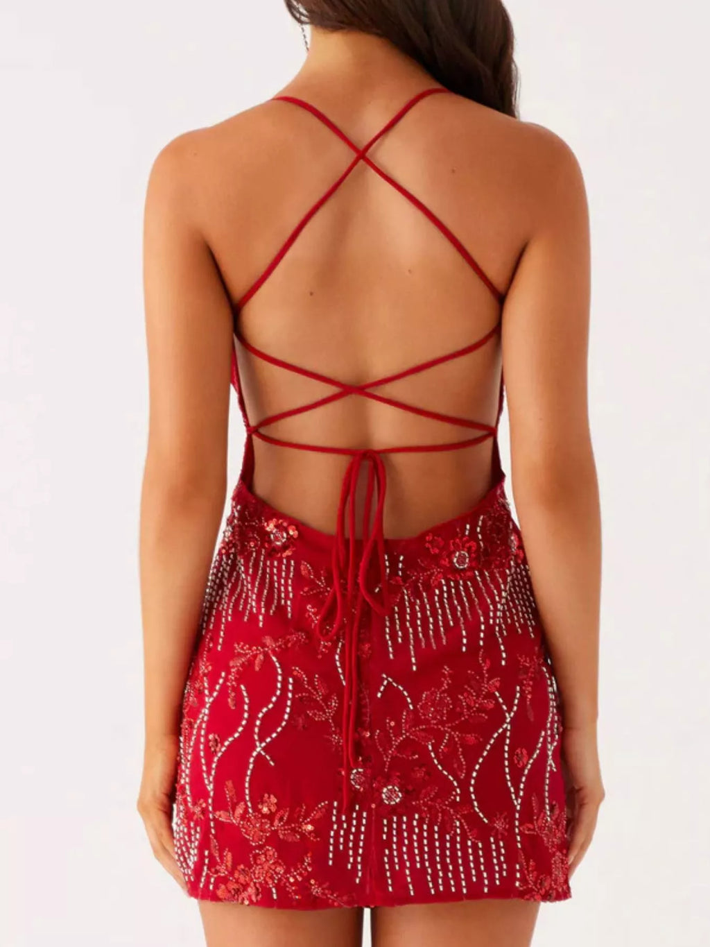 Red dress with intricate back design on a white background