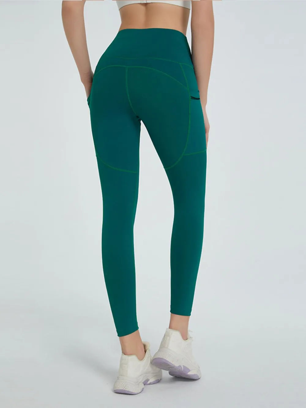 Teal leggings worn by a person on a white background