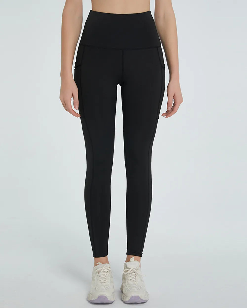 Person wearing black leggings on a white background