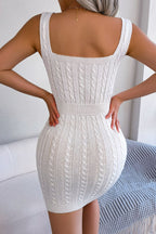 White knitted dress worn by a person, with a neutral background