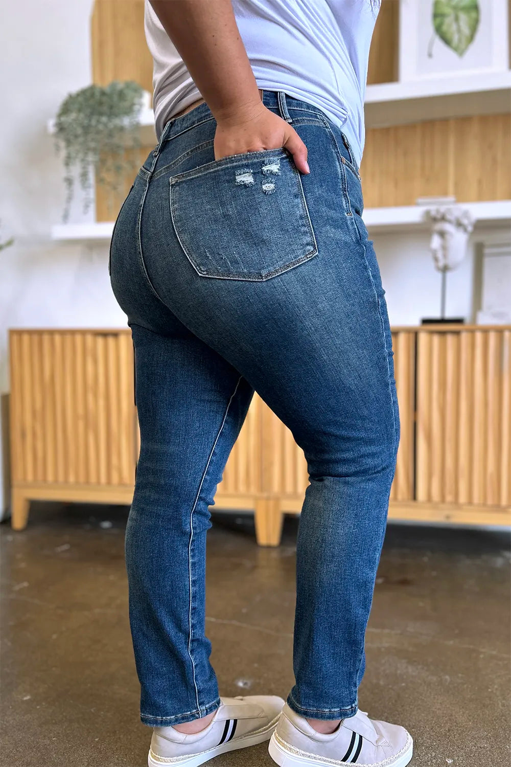 Person wearing blue jeans with a blurred background